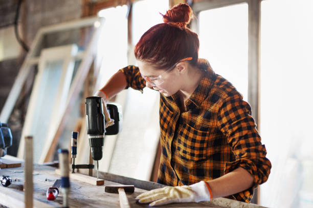 istock Female carpenter screwing her work together 644430990