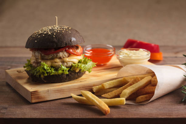 istock Trendy burger with chicken in black bun 644431788
