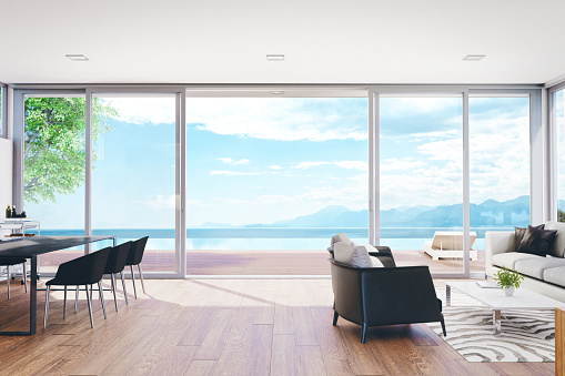 Modern luxury living room with pool and beautiful ocean view.