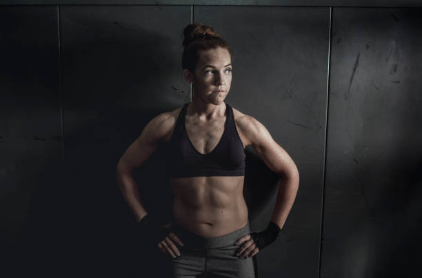 istock Tough and Athletic Woman Leaning up Against a Wall 644495558