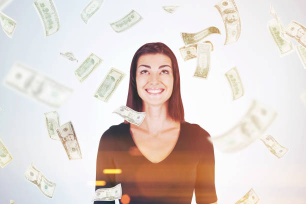 istock Happy woman in black, dollar bills falling, toned 644512362