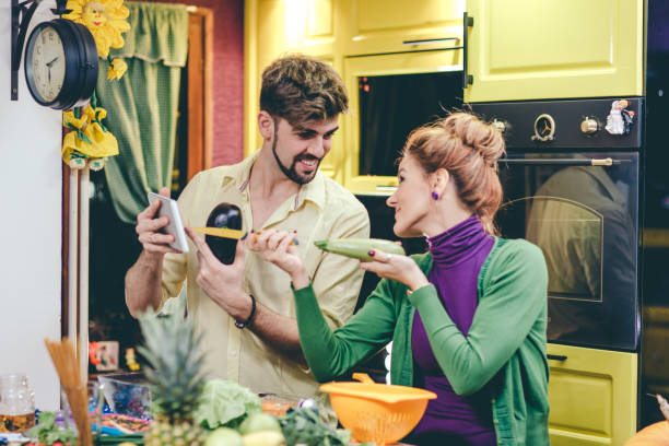 istock Man and woman preparing dinner 644553072