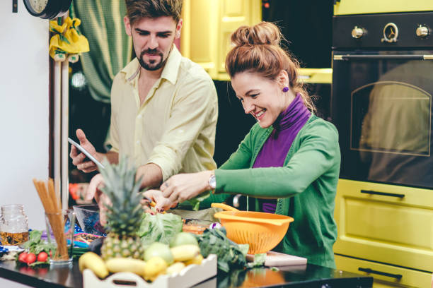 istock Man and woman preparing dinner 644554272