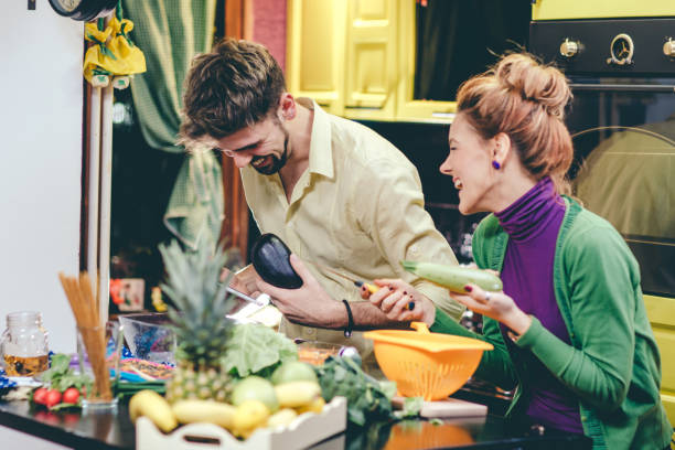 istock Man and woman preparing dinner 644556060