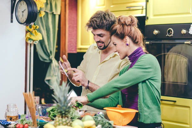 istock Man and woman preparing dinner 644560966