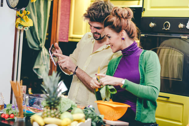 istock Man and woman preparing dinner 644562590