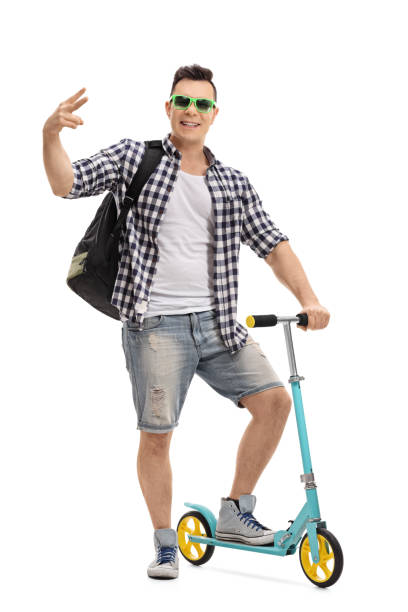 istock Cheerful cool man with a scooter gesturing with his hand 644570790