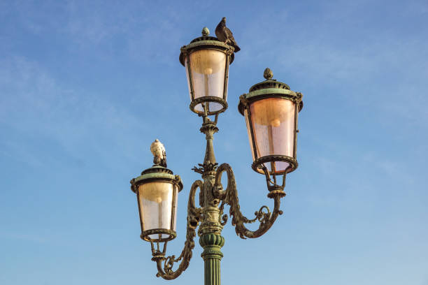 istock Classic old lamp post isolated on a blue sky background close up 644574984