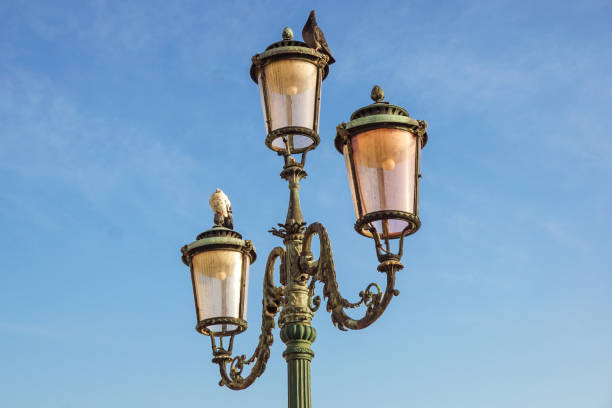 istock Classic old lamp post isolated on a blue sky background close up 644575168