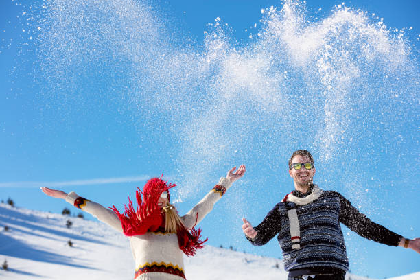 istock Winter couple having fun playing in snow outdoors. 644587828