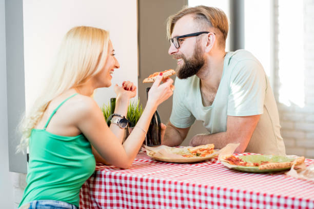 istock Couple eating pizza at home 644588108
