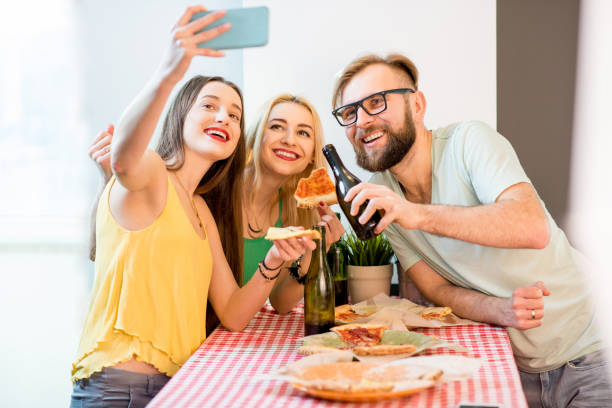 istock Friends having pizza party at home 644588640