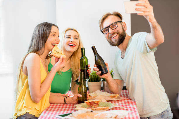 istock Friends having pizza party at home 644589012