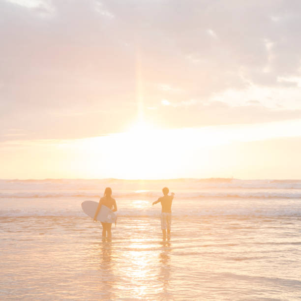 istock Surfer girl and instructor head out to surf 644595771