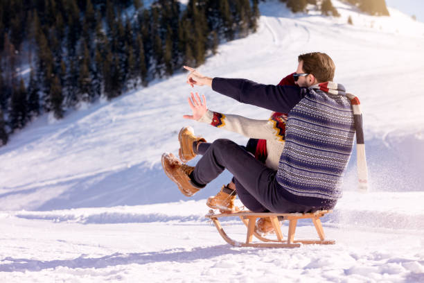 istock Young Couple Sledding And Enjoying On Sunny Winter Day 644615188