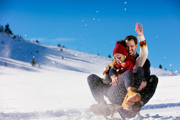 istock Young Couple Sledding And Enjoying On Sunny Winter Day 644629244