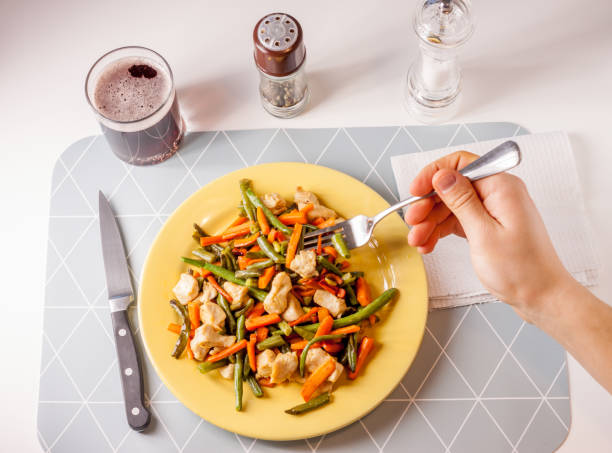 istock vegetables with meat on yellow plate 644635450