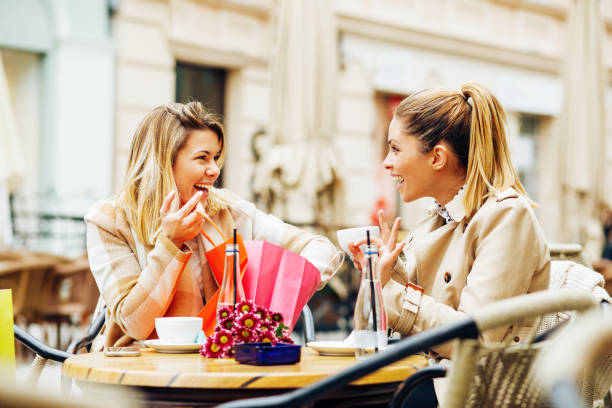 istock Two women have fun after shopping in cafe 644644596