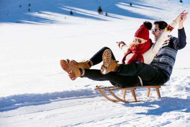 istock Young Couple Sledding And Enjoying On Sunny Winter Day 644655616