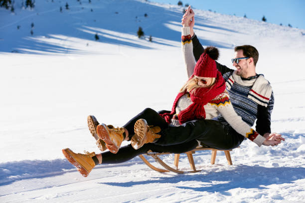 istock Young Couple Sledding And Enjoying On Sunny Winter Day 644665376