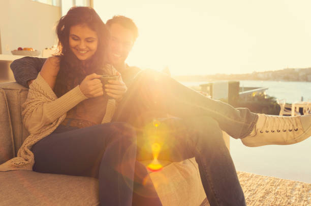 istock Couple on the sofa at sunrise. 644673446