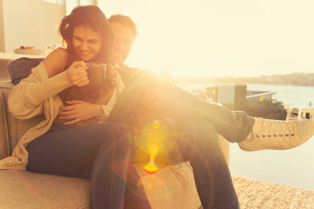 istock Couple on the sofa at sunrise. 644673448