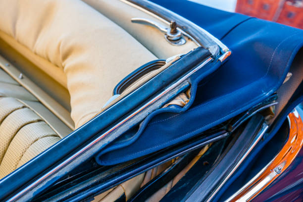 Color and beauty of vintage cars. Convertible top of an old luxury automobile. Leather seats. Vibrant colors.