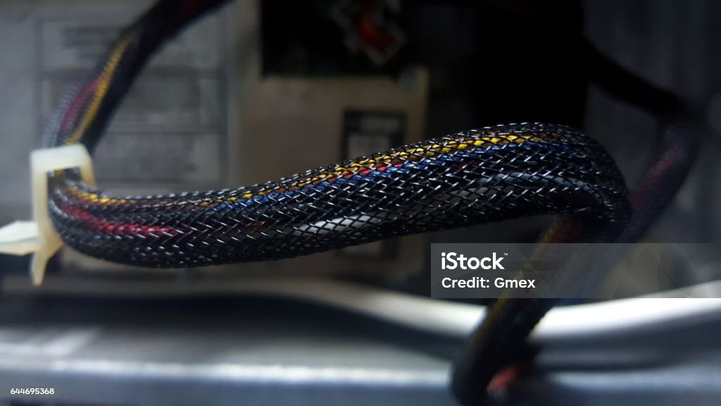 Closeup of a flexible mesh sleeve for wires. Closeup of a mesh sleeve for wires. Cable Stock Photo