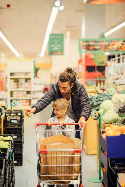 istock Father And His Daughter In A Supermarket 644700716