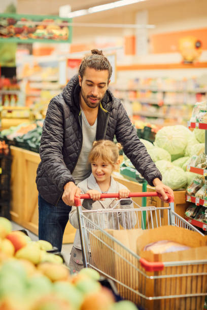 istock Father And His Daughter In A Supermarket 644702824