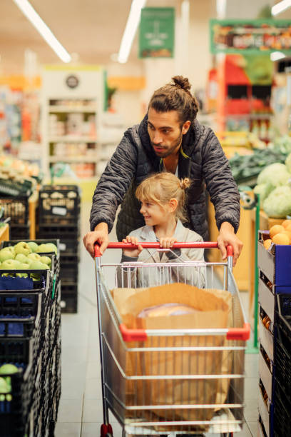istock Father And His Daughter In A Supermarket 644702932