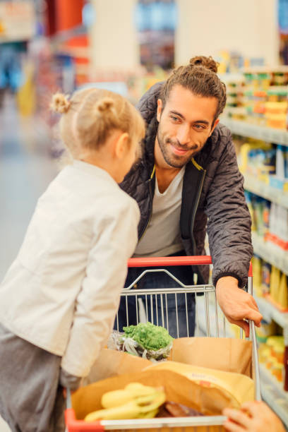 istock Father And His Daughter In A Supermarket 644703382