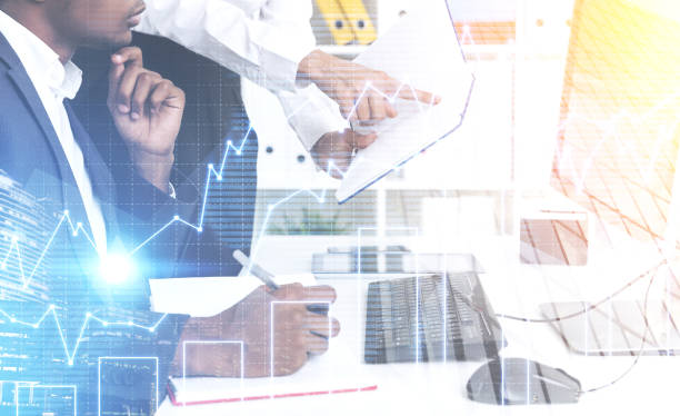 istock Side view of man and woman in office, graphs 644716924
