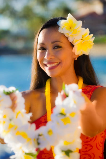 istock Hawaiian Hula Dancer Welcoming Visitor with Lei 644748764