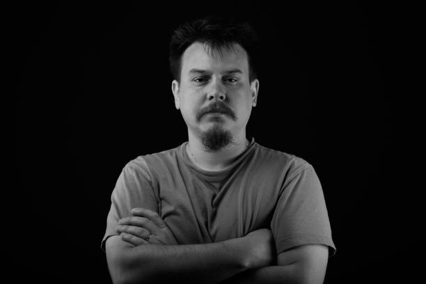 istock Guy standing arms crossed on black background 644803956