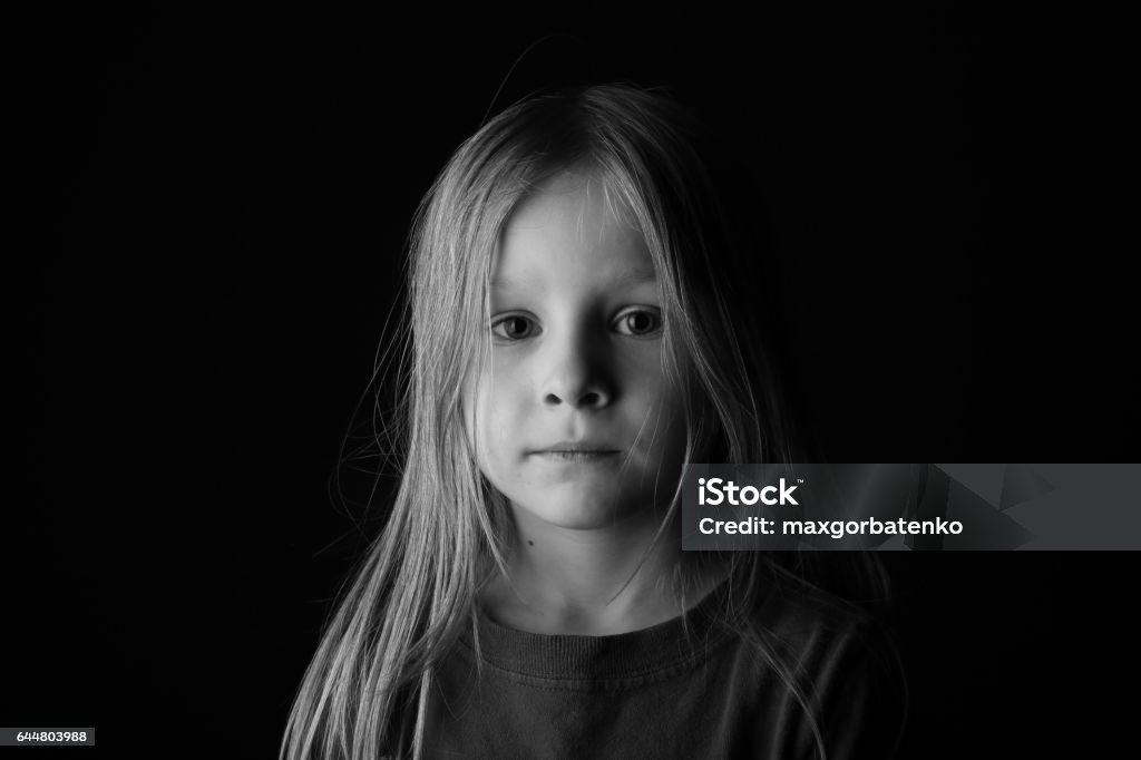 An 7 Year Old Boy With Long Hair Looking Serious On Black Background Stock  Photo - Download Image Now - iStock