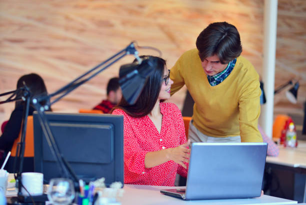 istock business couple working together on project at modern startup office 644820244
