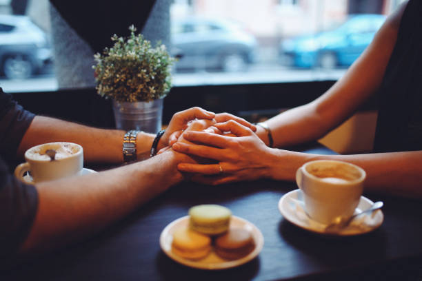 istock Young couple holding hands in the cafe 644830418
