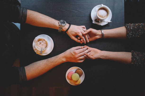 istock Young couple holding hands in the cafe 644831730