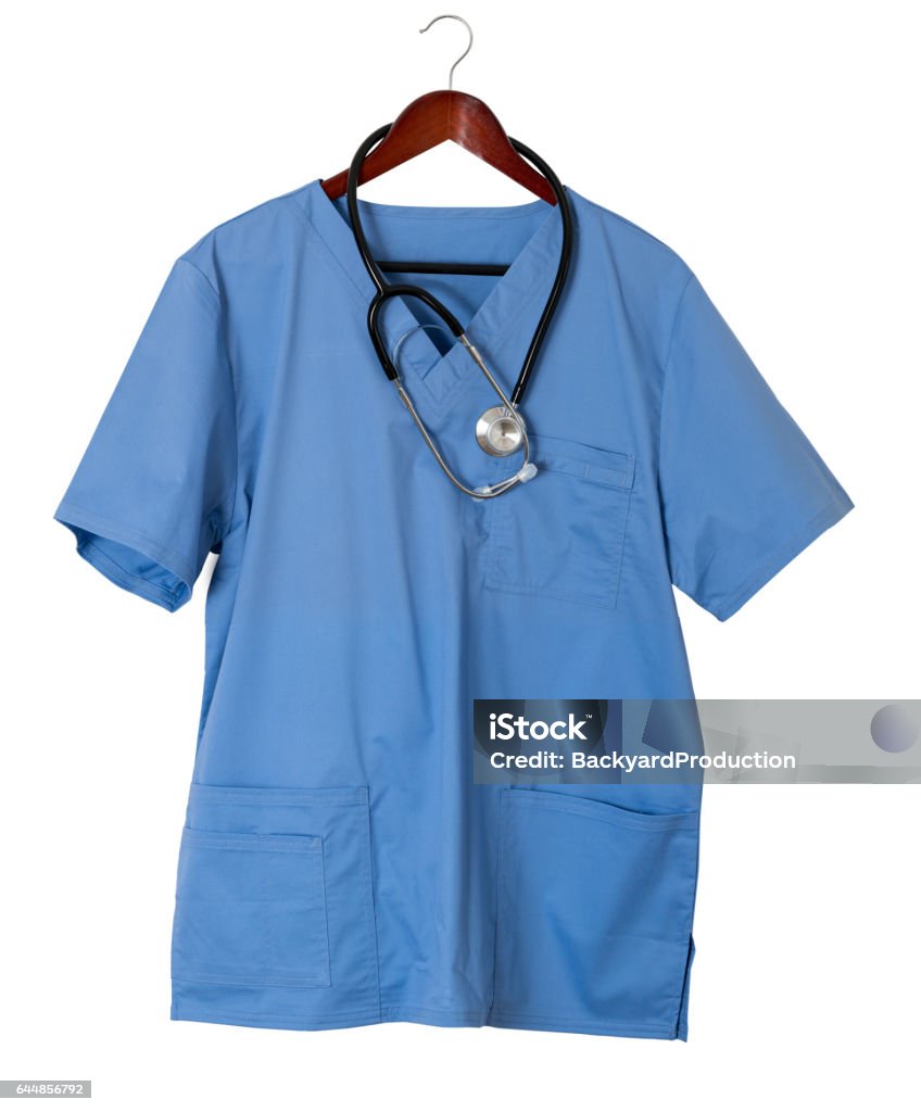 Blue scrubs shirt for medical professional hanging on door Blue medical scrubs uniform shirt hanging on a hook on back of door with stethoscope with copy space for message Medical Scrubs Stock Photo