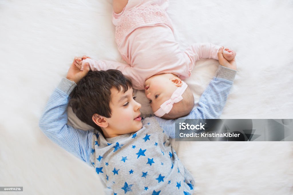 TOP VIEW: Portrait of cute brother with his little sister Baby - Human Age Stock Photo