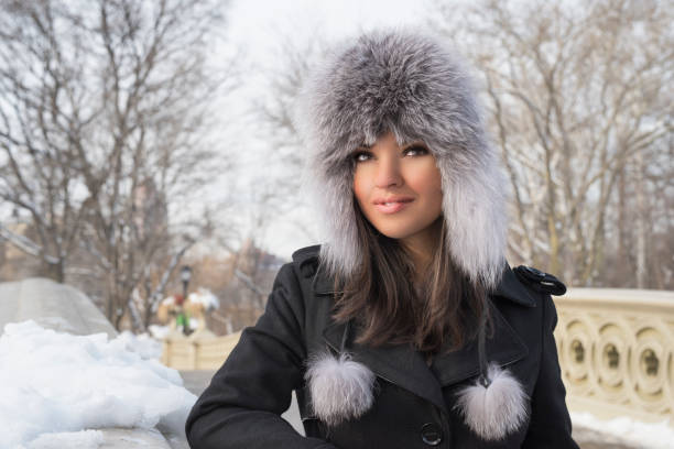 istock Young woman in warm hat in snowy park 644916366