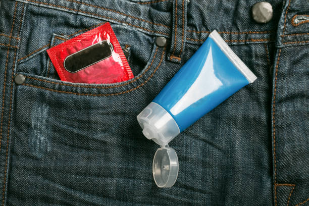 Condom package in back pocket jeans. Protect HIV and for world AIDS day