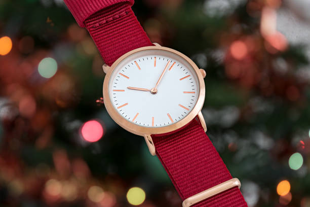istock Red nylon strap wrist watch in front of Christmas lights 644922912