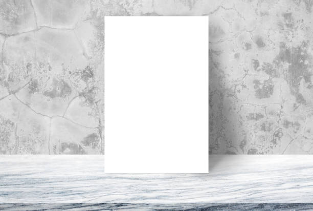 istock Blank White paper poster on stone table top at concrete wall 644925660
