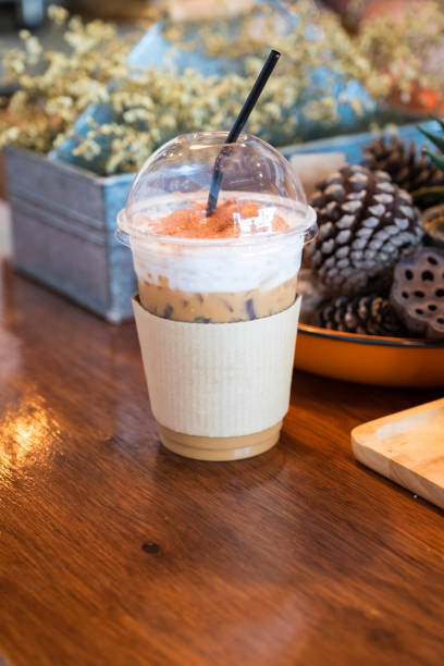 Close up ice coffee on wood table in cafe shop.