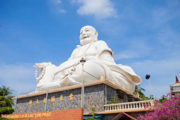 Photo of Maitreya Buddha statue located in the famous Vinh Trang pagoda in My Tho city, Tien Giang province, Vietnam.