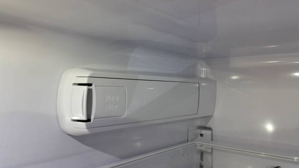 Water filter enclosure inside a refrigerator stock photo