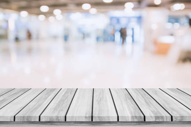 istock Empty top of wooden table with blur shopping mall background. 644947984
