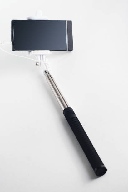 istock Smartphone on a selfie stick on white background, 644951700